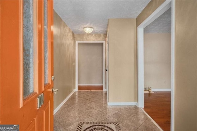 corridor featuring a textured ceiling