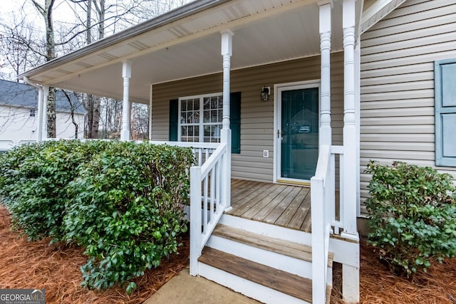 view of exterior entry with covered porch