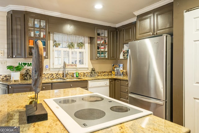 kitchen featuring white appliances, ornamental molding, sink, and dark brown cabinets