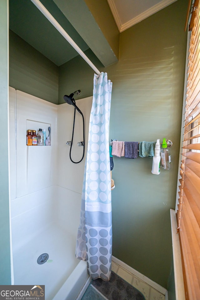 bathroom featuring crown molding, tile patterned flooring, and a shower with shower curtain