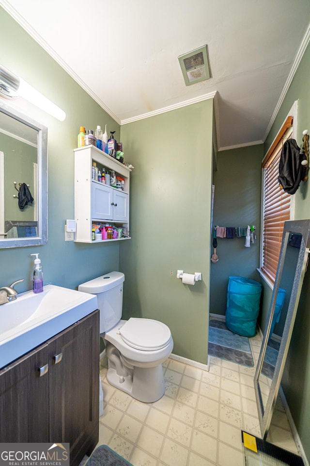 bathroom with ornamental molding, vanity, and toilet