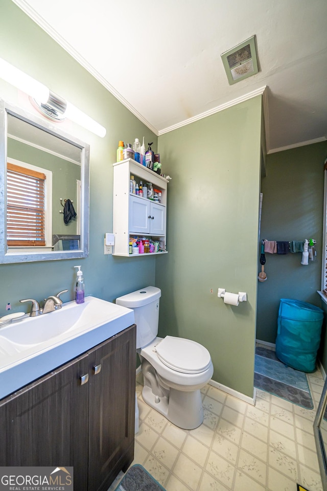 bathroom featuring ornamental molding, toilet, and vanity