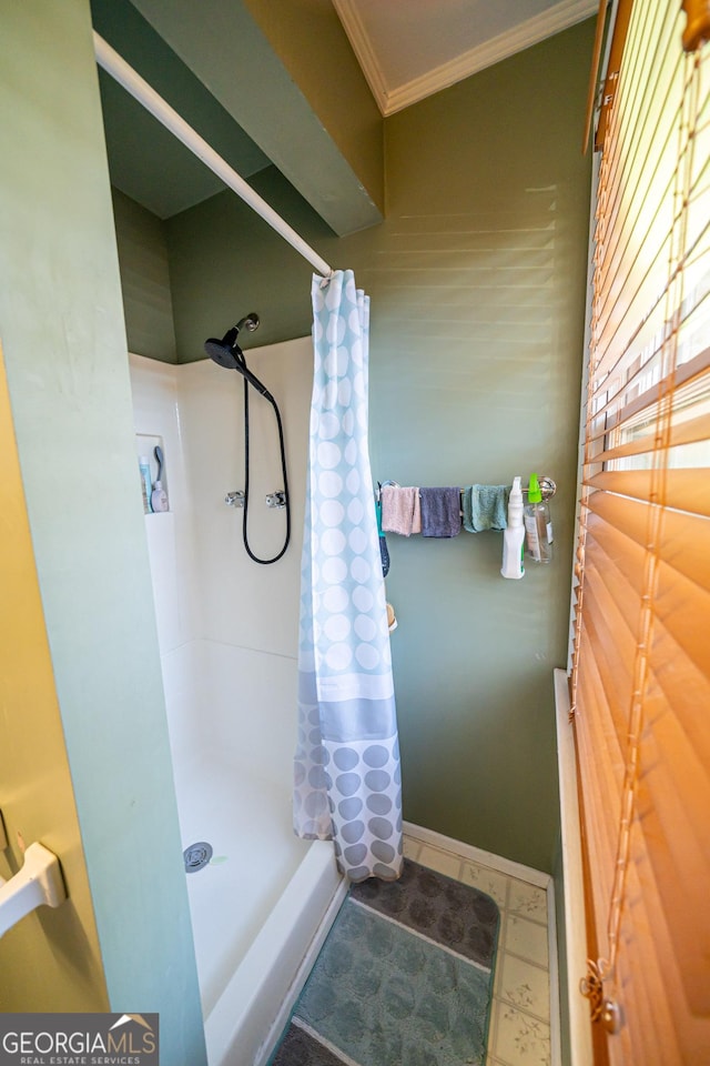 bathroom with curtained shower and ornamental molding