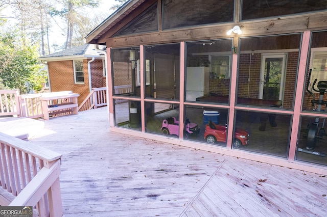 wooden deck featuring a sunroom