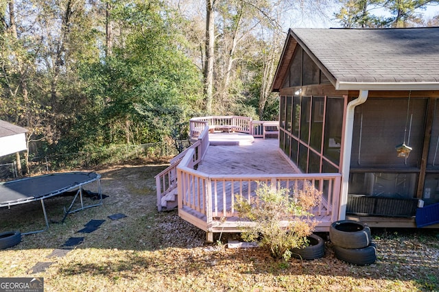 deck with a trampoline and a sunroom