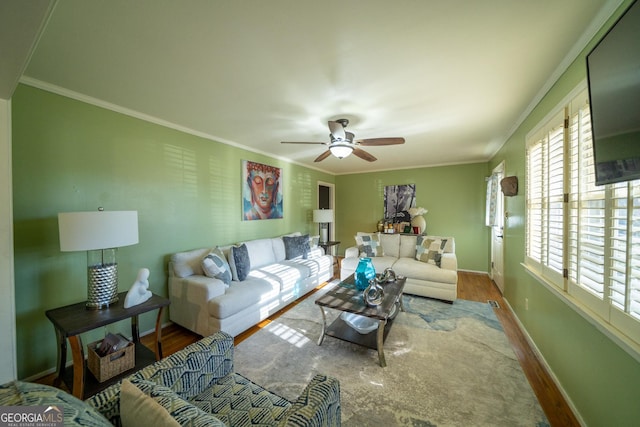 living room featuring ornamental molding, wood-type flooring, and ceiling fan