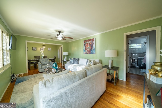 living room featuring crown molding, ceiling fan, and hardwood / wood-style floors