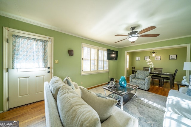 living room featuring ornamental molding, ceiling fan, and light hardwood / wood-style floors