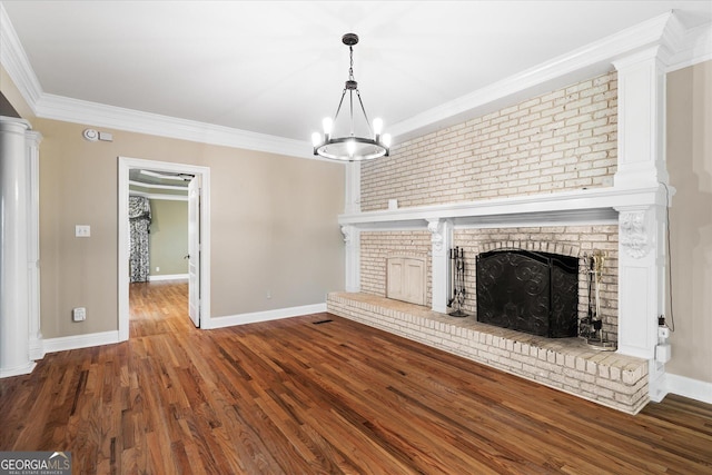 unfurnished living room featuring ornamental molding, a fireplace, baseboards, and wood finished floors