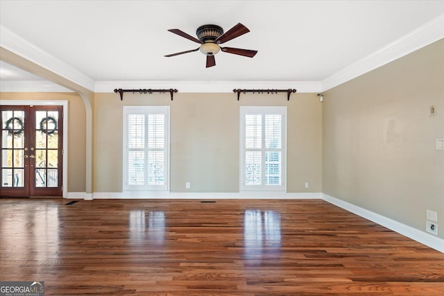 unfurnished room with crown molding, french doors, wood finished floors, and a healthy amount of sunlight