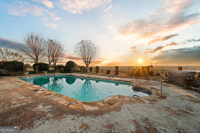 view of pool featuring a hot tub, a fenced backyard, a fenced in pool, and a patio