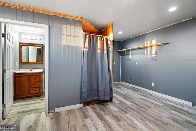 spare room featuring baseboards, light wood finished floors, and recessed lighting