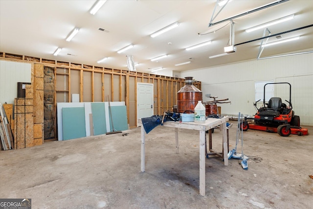 garage featuring a garage door opener and visible vents