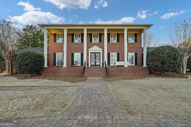 greek revival house with french doors and brick siding