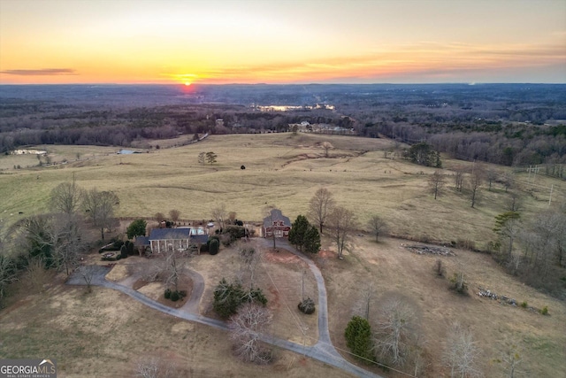 aerial view at dusk featuring a rural view