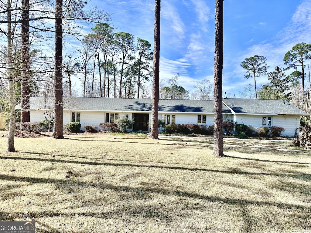 ranch-style house with a front lawn