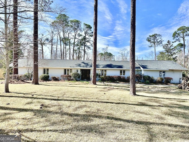 ranch-style house with a front lawn