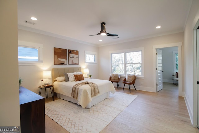 bedroom with crown molding, ceiling fan, light hardwood / wood-style floors, and multiple windows