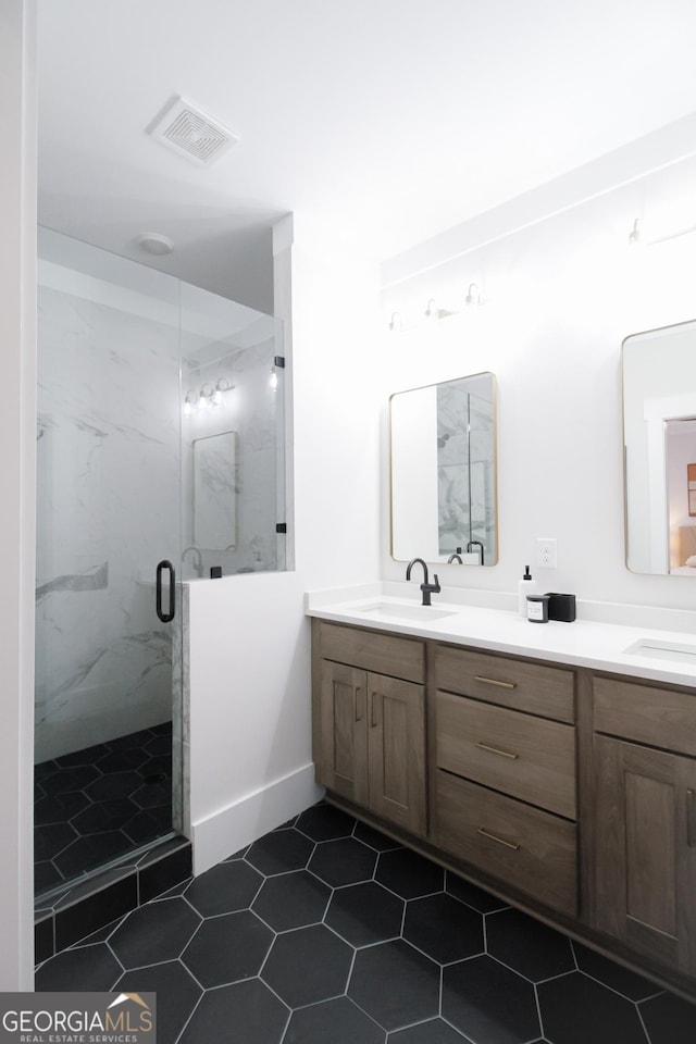 bathroom featuring vanity and a shower with shower door