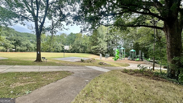 surrounding community with a playground and a lawn