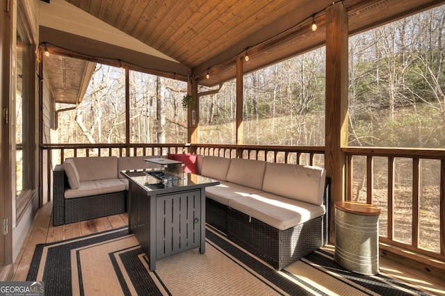 sunroom with wood ceiling, lofted ceiling, and a wealth of natural light