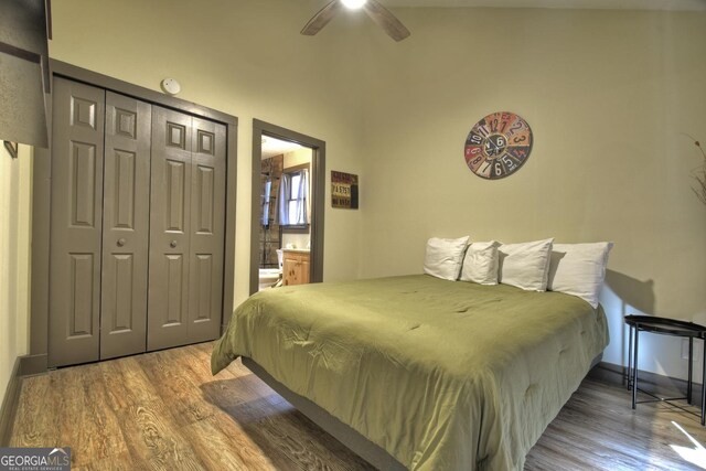 bedroom featuring hardwood / wood-style flooring, connected bathroom, ceiling fan, and a closet