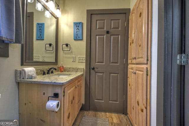 bathroom with vanity and hardwood / wood-style floors