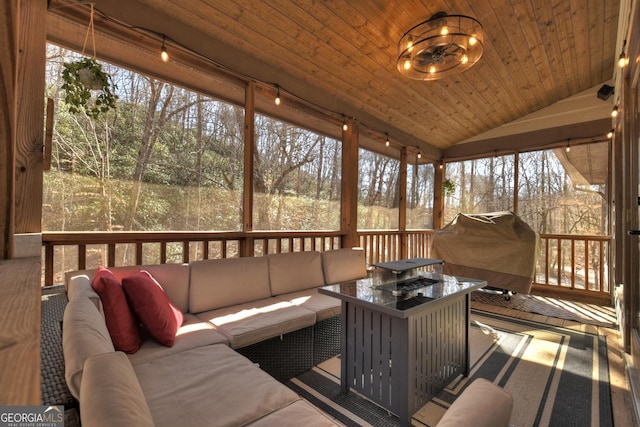 sunroom featuring lofted ceiling and wooden ceiling