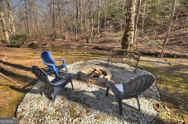 view of yard with an outdoor fire pit