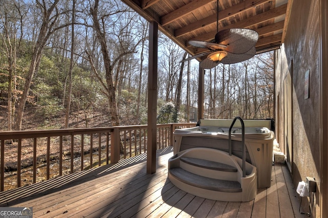 wooden deck featuring a hot tub and ceiling fan