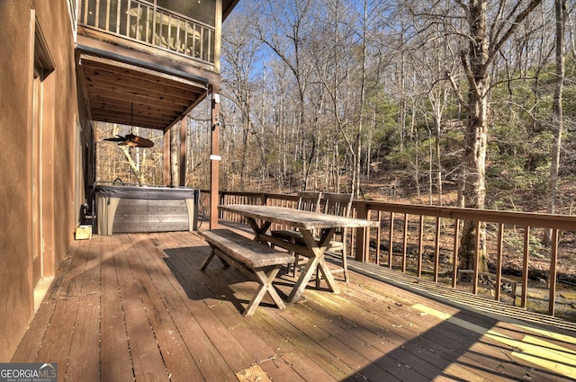 wooden terrace featuring a hot tub and ceiling fan