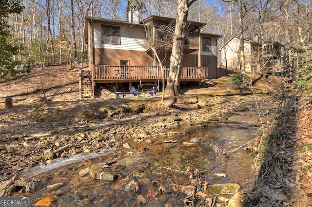 back of house featuring a deck