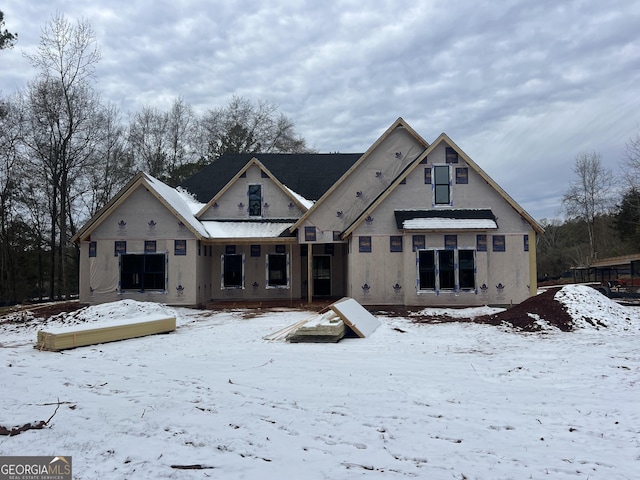 view of snow covered rear of property