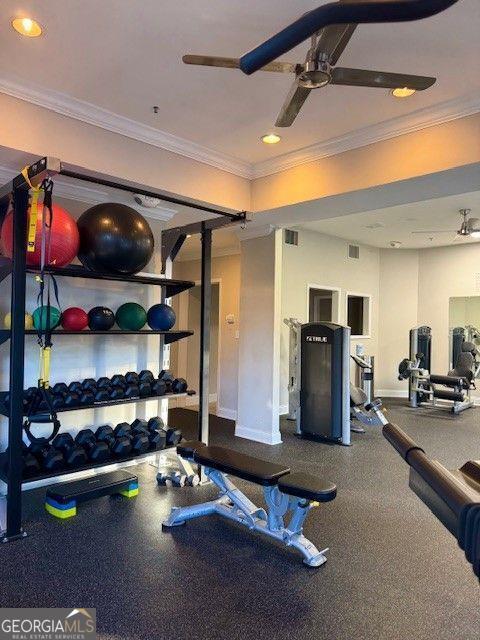 gym featuring ornamental molding and ceiling fan