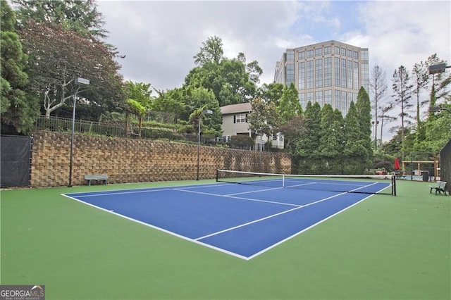 view of tennis court with fence