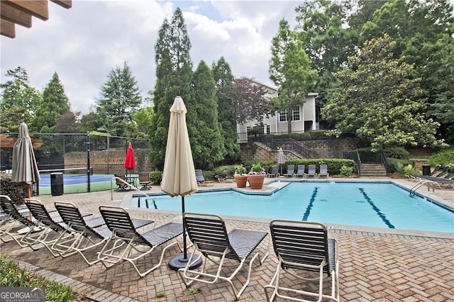 community pool featuring a patio area and fence