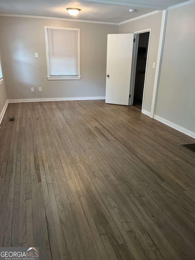 unfurnished room featuring crown molding and hardwood / wood-style floors