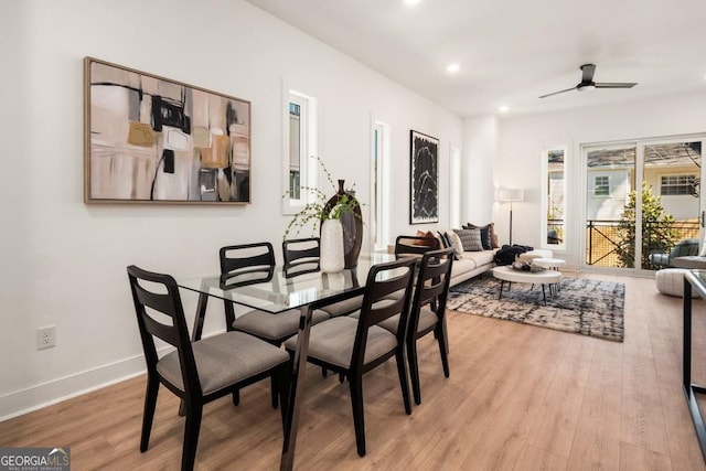 dining space featuring ceiling fan and light wood-type flooring