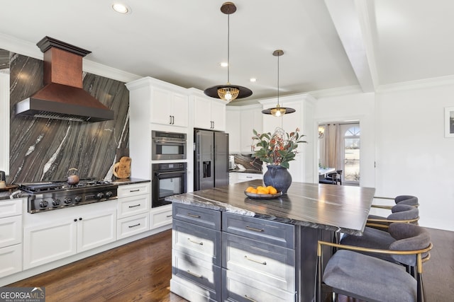 kitchen featuring appliances with stainless steel finishes, custom range hood, and white cabinets