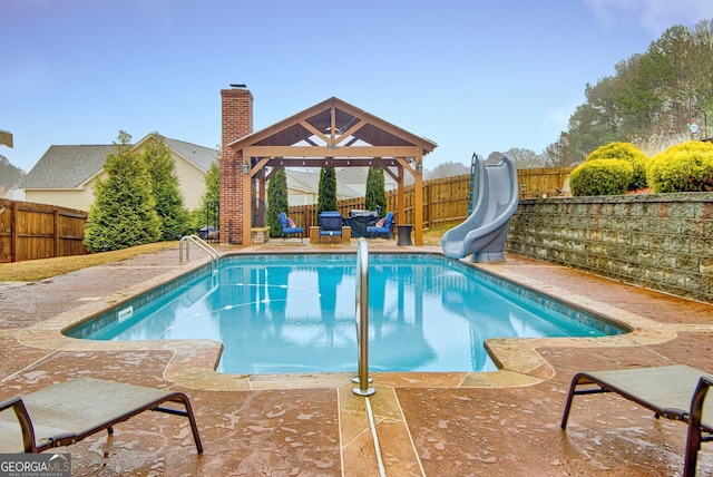 view of swimming pool with a gazebo and a water slide