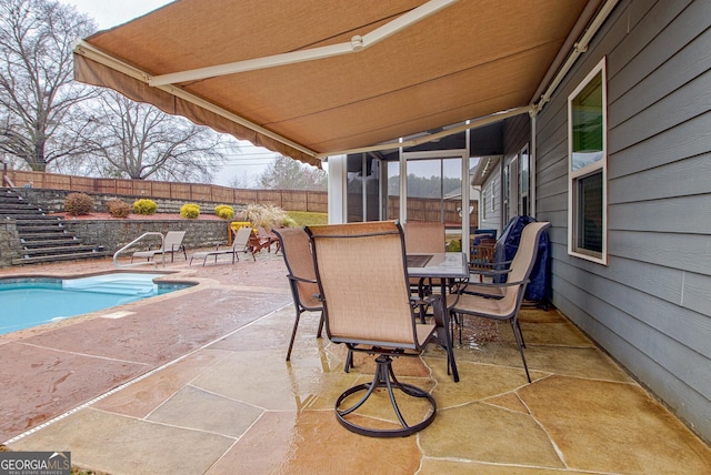 view of patio featuring a fenced in pool