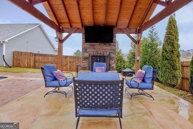 view of patio featuring an outdoor stone fireplace