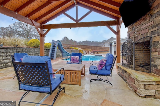 view of patio featuring a fenced in pool and a gazebo