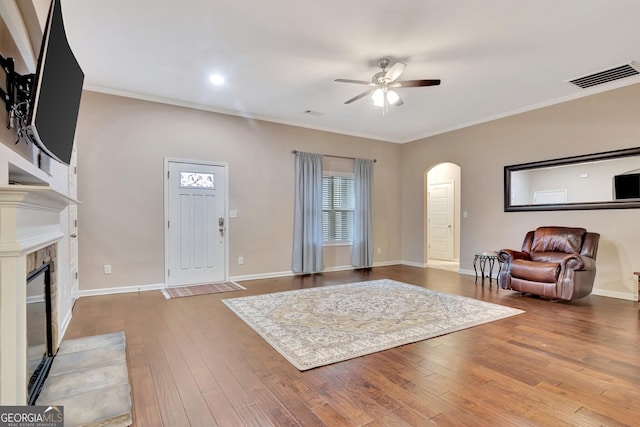 living room featuring ornamental molding, hardwood / wood-style floors, and ceiling fan