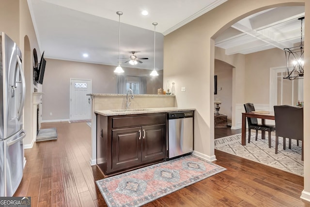 kitchen with sink, decorative light fixtures, dark brown cabinets, hardwood / wood-style flooring, and stainless steel appliances