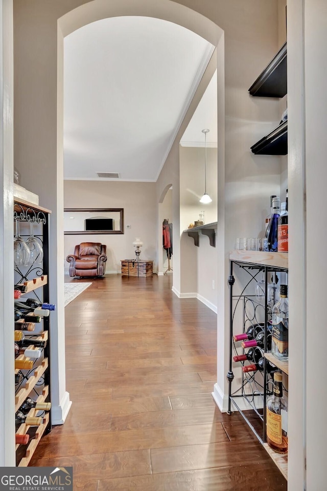 corridor featuring hardwood / wood-style flooring and crown molding