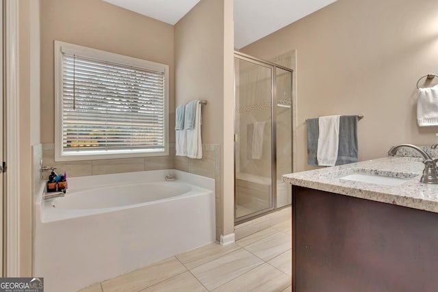 bathroom featuring tile patterned floors, shower with separate bathtub, and vanity