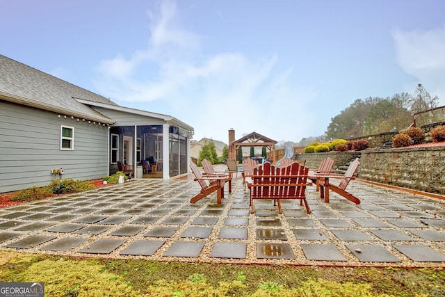 view of patio / terrace with a gazebo and a sunroom