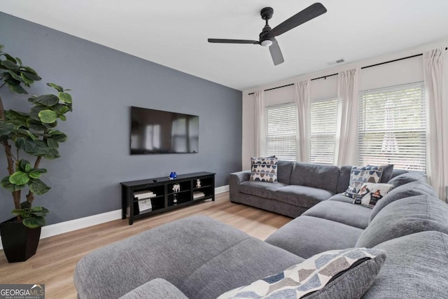 living room with hardwood / wood-style flooring and ceiling fan