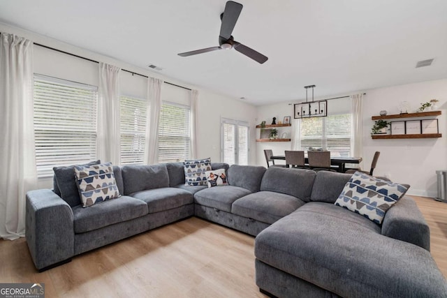 living room with ceiling fan and light hardwood / wood-style floors